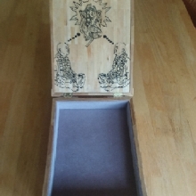Inmate Arjuna dasa—from Ohio—teaches a woodworking class in his prison. He made this box as a gift for Bhakti-latā dasi, to thank her for all her help.  If you look closer, you will see that, except the edges, the cover is made with Popsicle sticks. The images are burnt on the wood itself. The inside is lined with a velvety material. It is a fine piece of craftsmanship.