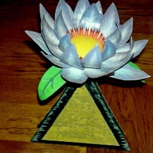 Inmate Casey B.—from Arizona—made this paper lotus flower. When devotees come to give programs, he makes dozens of them to decorate the altar and make garlands to offer those devotees.